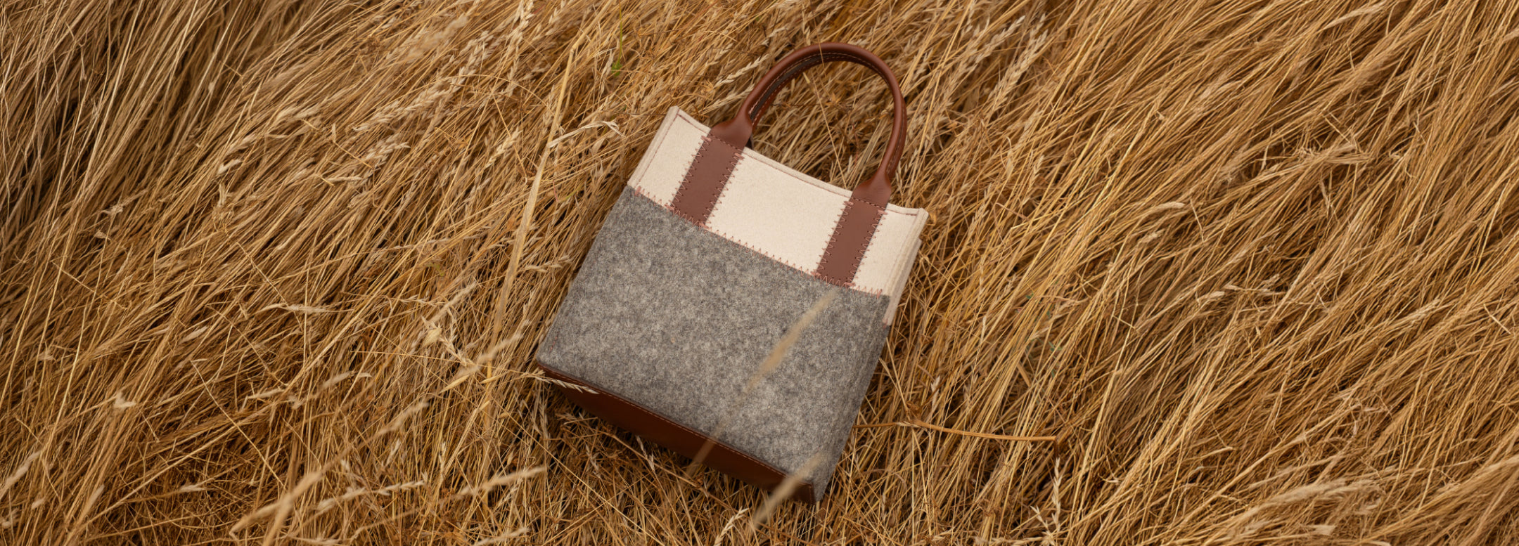 Person wearing a beige dress holds a tan crossbody bag. Text on image: 30% Off Sitewide. Small print: *Excludes everyday icons and final sale.